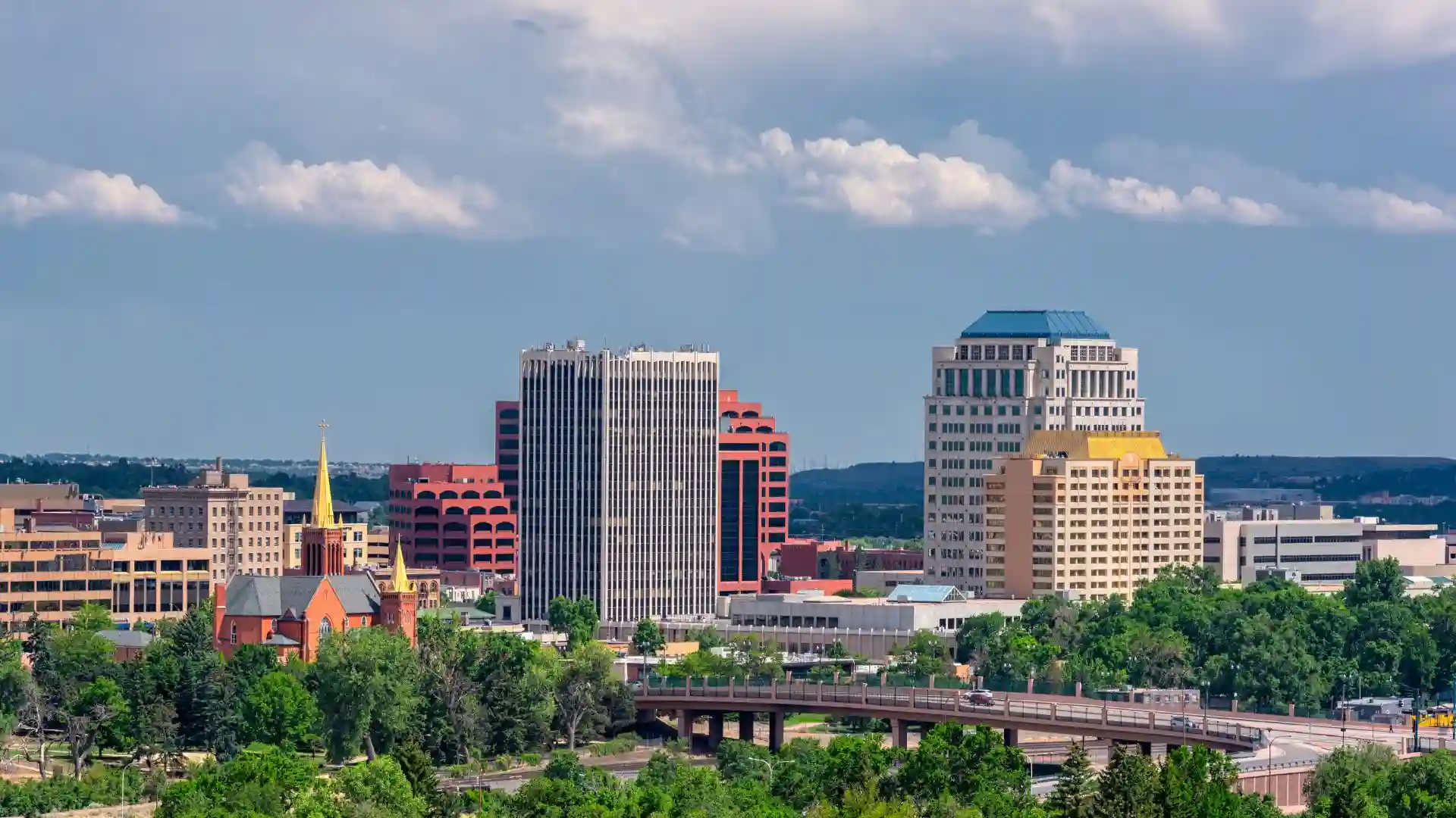 Colorado Springs city skyline with cloudy sky.