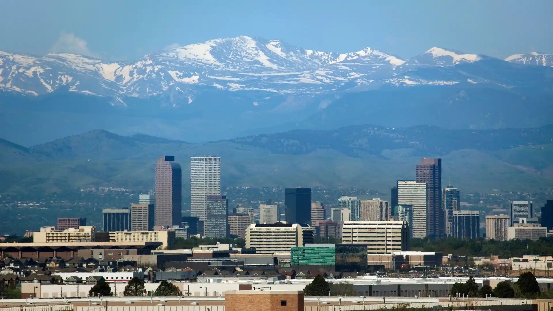 Denver skyline with mountains in the background.