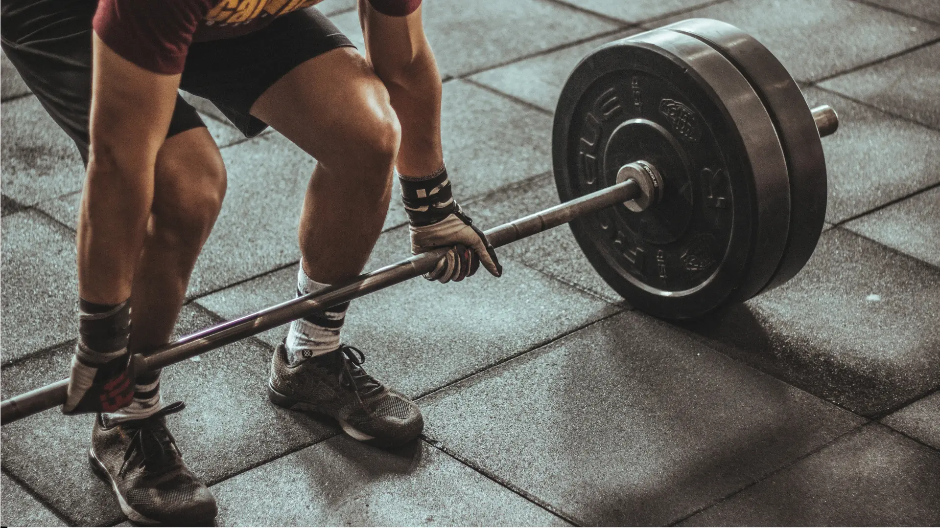 Person lifting barbell in gym