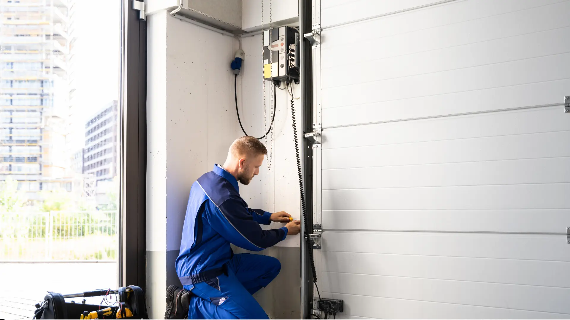Technician repairing garage door mechanism