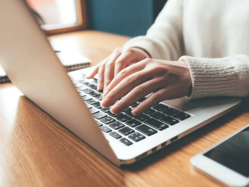 internet marketing services Person typing on a laptop keyboard.