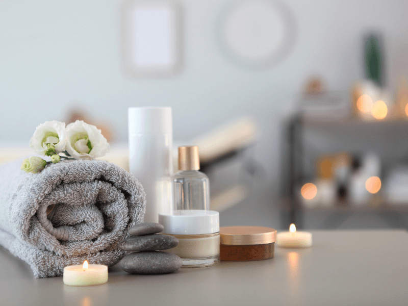 Relaxing spa essentials with candles and flowers.
