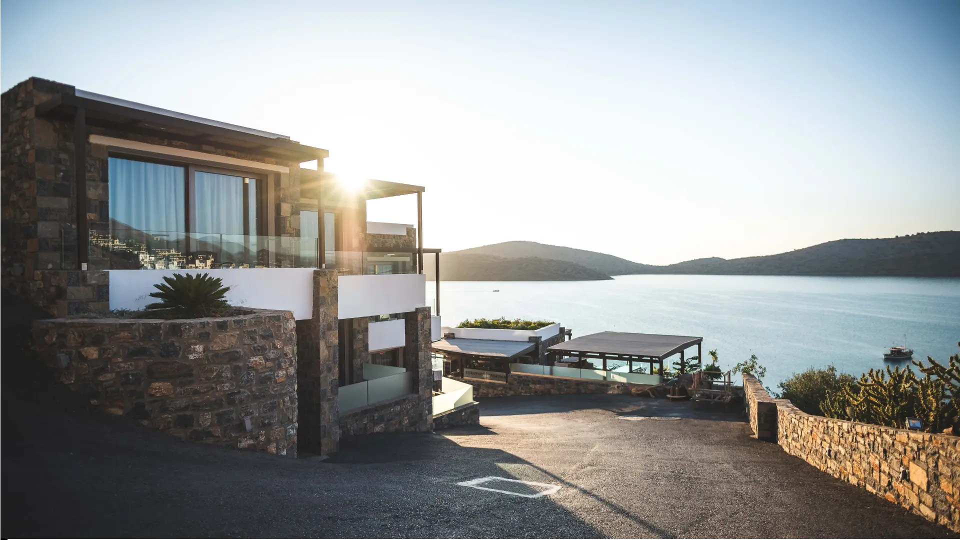 Contemporary villa with ocean view during sunrise.