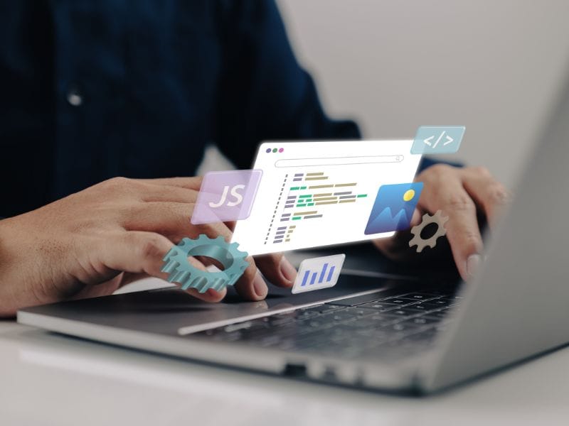 Person coding on laptop with software icons floating.
